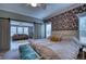 Bright main bedroom boasts a king-size bed and floral accent wall at 14150 Manatee Rd, Parrish, FL 34219