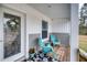 Front porch with teal chairs and wreath on door at 14150 Manatee Rd, Parrish, FL 34219