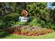 Pelican Cove community entrance sign with colorful landscaping at 1510 Pelican Point Dr # Ba168, Sarasota, FL 34231