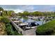 View of a marina with sailboats and powerboats docked at slips, surrounded by green foliage at 1601 Bayhouse Point Dr # Ba101, Sarasota, FL 34231