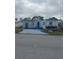 White single-wide manufactured home with blue trim and small yard at 1660 Old Elm St, Sarasota, FL 34234