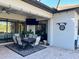 Covered patio with dining table, chairs, and dartboard at 17601 Hickok Belt Loop, Bradenton, FL 34211