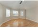 Bedroom featuring three windows, wood floors, and neutral walls at 1825 Bayshore Dr, Terra Ceia, FL 34250