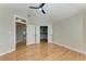 Bedroom with vaulted ceiling featuring hardwood floors and walk-in closet at 1825 Bayshore Dr, Terra Ceia, FL 34250