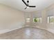 Neutral-toned bedroom with tile floors and multiple windows at 1825 Bayshore Dr, Terra Ceia, FL 34250