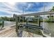 Private dock with boat lift, perfect for enjoying Florida's waterways at 1825 Bayshore Dr, Terra Ceia, FL 34250