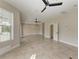 Large bonus room with tile floors and ceiling fans at 1825 Bayshore Dr, Terra Ceia, FL 34250