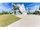 Two-story home with white siding, spacious driveway, and lush landscaping at 1825 Bayshore Dr, Terra Ceia, FL 34250