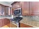 Close-up shot of the stove and granite countertops in the kitchen at 1825 Bayshore Dr, Terra Ceia, FL 34250