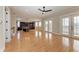 Expansive living room area with hardwood floors, ceiling fan, and access to the outdoors at 1825 Bayshore Dr, Terra Ceia, FL 34250