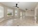 Bright living room featuring tile floors and access to a waterfront patio at 1825 Bayshore Dr, Terra Ceia, FL 34250