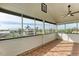 Screened porch with tile floor, ceiling fan, and water views at 1825 Bayshore Dr, Terra Ceia, FL 34250