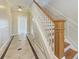 Elegant staircase with wood railing and tile flooring at 1825 Bayshore Dr, Terra Ceia, FL 34250