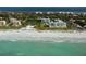 Aerial view of beachfront community, featuring condos, lush landscaping and beach access at 2110 Harbourside Dr # 522, Longboat Key, FL 34228