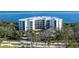 Bird's-eye view of a waterfront condo building with lush landscaping at 2110 Harbourside Dr # 522, Longboat Key, FL 34228