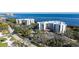 An aerial view showcasing two condo buildings near the water and golf course at 2110 Harbourside Dr # 522, Longboat Key, FL 34228