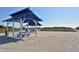 Beachfront picnic area with shaded tables under blue pavilions at 2110 Harbourside Dr # 522, Longboat Key, FL 34228