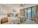 Guest bedroom with two twin beds and access to balcony at 2110 Harbourside Dr # 522, Longboat Key, FL 34228