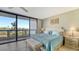 Main bedroom with a king-size bed and access to a private balcony at 2110 Harbourside Dr # 522, Longboat Key, FL 34228