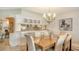 Bright dining room with a large chandelier and kitchen access at 2110 Harbourside Dr # 522, Longboat Key, FL 34228
