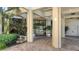 Condo building entrance with paved pathway and landscaping at 2110 Harbourside Dr # 522, Longboat Key, FL 34228