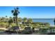 Landscaped grounds with palm trees and a scenic waterfront view at 2110 Harbourside Dr # 522, Longboat Key, FL 34228