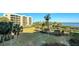 Landscaped grounds with palm trees and a view of the water at 2110 Harbourside Dr # 522, Longboat Key, FL 34228