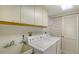 Bright laundry room with washer, dryer, cabinets, and utility sink at 2110 Harbourside Dr # 522, Longboat Key, FL 34228