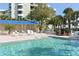Relaxing pool area with shaded seating at 2110 Harbourside Dr # 522, Longboat Key, FL 34228