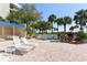 Spacious pool deck with lounge chairs and potted plants at 2110 Harbourside Dr # 522, Longboat Key, FL 34228