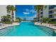 Inviting community pool with lounge chairs and water views at 2110 Harbourside Dr # 522, Longboat Key, FL 34228
