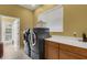 Laundry room with washer, dryer, and cabinets at 2500 Farms Ct, Sarasota, FL 34240