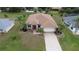 Single-story house with a paved driveway and landscaping at 25067 Palisade Rd, Punta Gorda, FL 33983