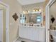 Double vanity with ample storage in a bright, well-lit bathroom at 25067 Palisade Rd, Punta Gorda, FL 33983