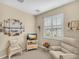 Bedroom with TV, comfy recliner, and plantation shutters at 25067 Palisade Rd, Punta Gorda, FL 33983