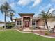 House entrance with red door and manicured landscaping at 25067 Palisade Rd, Punta Gorda, FL 33983