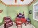 Home office with wood desk, comfortable chair, and leafy decor at 25067 Palisade Rd, Punta Gorda, FL 33983