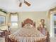 Main bedroom with king bed, window seat, and private access to outside at 25067 Palisade Rd, Punta Gorda, FL 33983