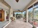 Relaxing screened porch with seating area and view of backyard at 25067 Palisade Rd, Punta Gorda, FL 33983