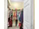 Well-organized walk-in closet with hanging clothes and shoe storage at 25067 Palisade Rd, Punta Gorda, FL 33983