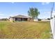 Spacious backyard featuring a home with screened patio at 2720 S Biscayne Dr, North Port, FL 34287