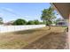 Backyard with a large grassy area and a pool in the distance at 2720 S Biscayne Dr, North Port, FL 34287