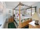 Bedroom with a wooden four-poster bed and window at 2720 S Biscayne Dr, North Port, FL 34287