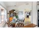 Dining area with glass-top table and wicker chairs, open to kitchen at 2720 S Biscayne Dr, North Port, FL 34287
