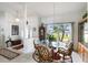 Dining room with glass-top table, wicker chairs, and large window at 2720 S Biscayne Dr, North Port, FL 34287