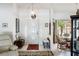 Bright entryway with tiled floor, bench, and view into dining area at 2720 S Biscayne Dr, North Port, FL 34287