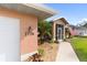 House entrance with walkway, screened porch, and American flag at 2720 S Biscayne Dr, North Port, FL 34287