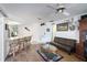 Gathering room with wood floors, leather sofa, and kitchen access at 2720 S Biscayne Dr, North Port, FL 34287