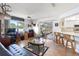 Gathering room with wood floors, leather sofa, and view of patio at 2720 S Biscayne Dr, North Port, FL 34287