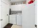 Convenient laundry room with washer, dryer, and cabinets at 2720 S Biscayne Dr, North Port, FL 34287